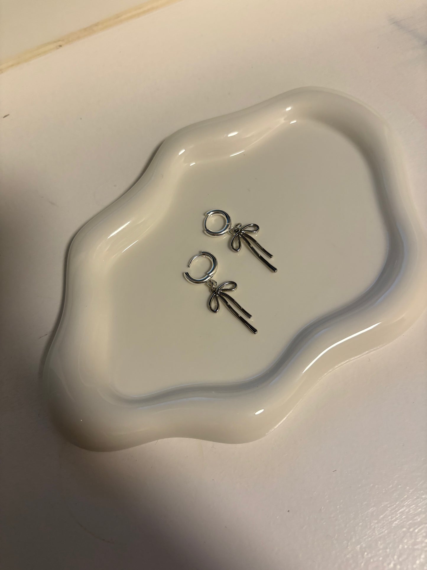 Silver huggie hoop bow earrings