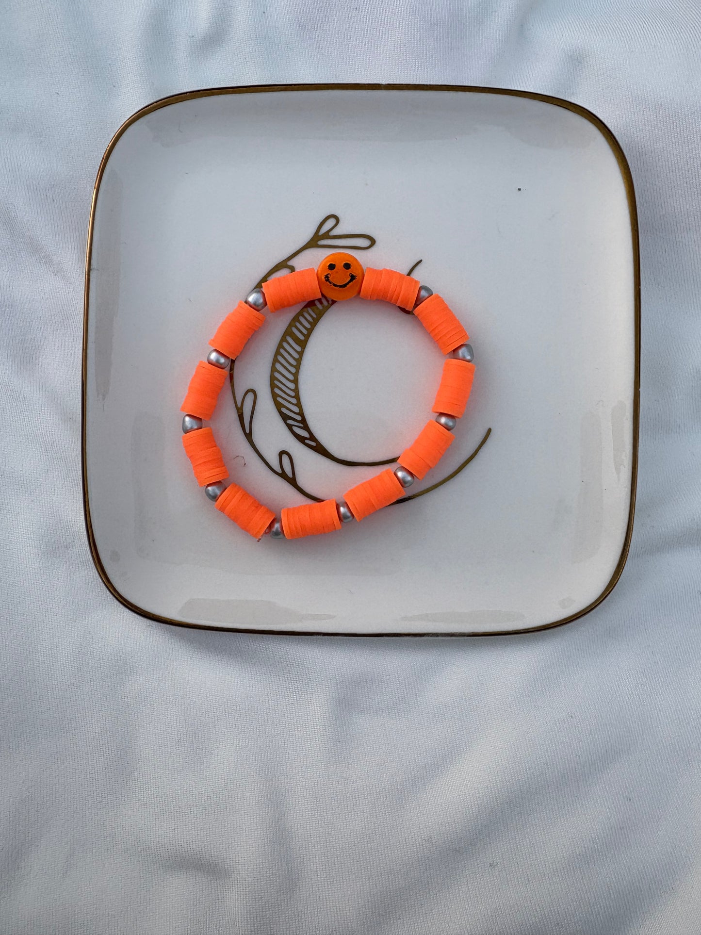 Neon orange smiley face bracelet