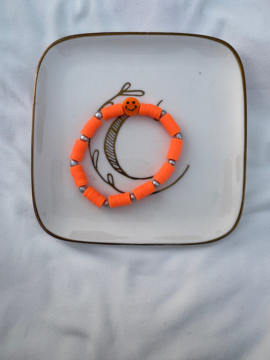 Neon orange smiley face bracelet