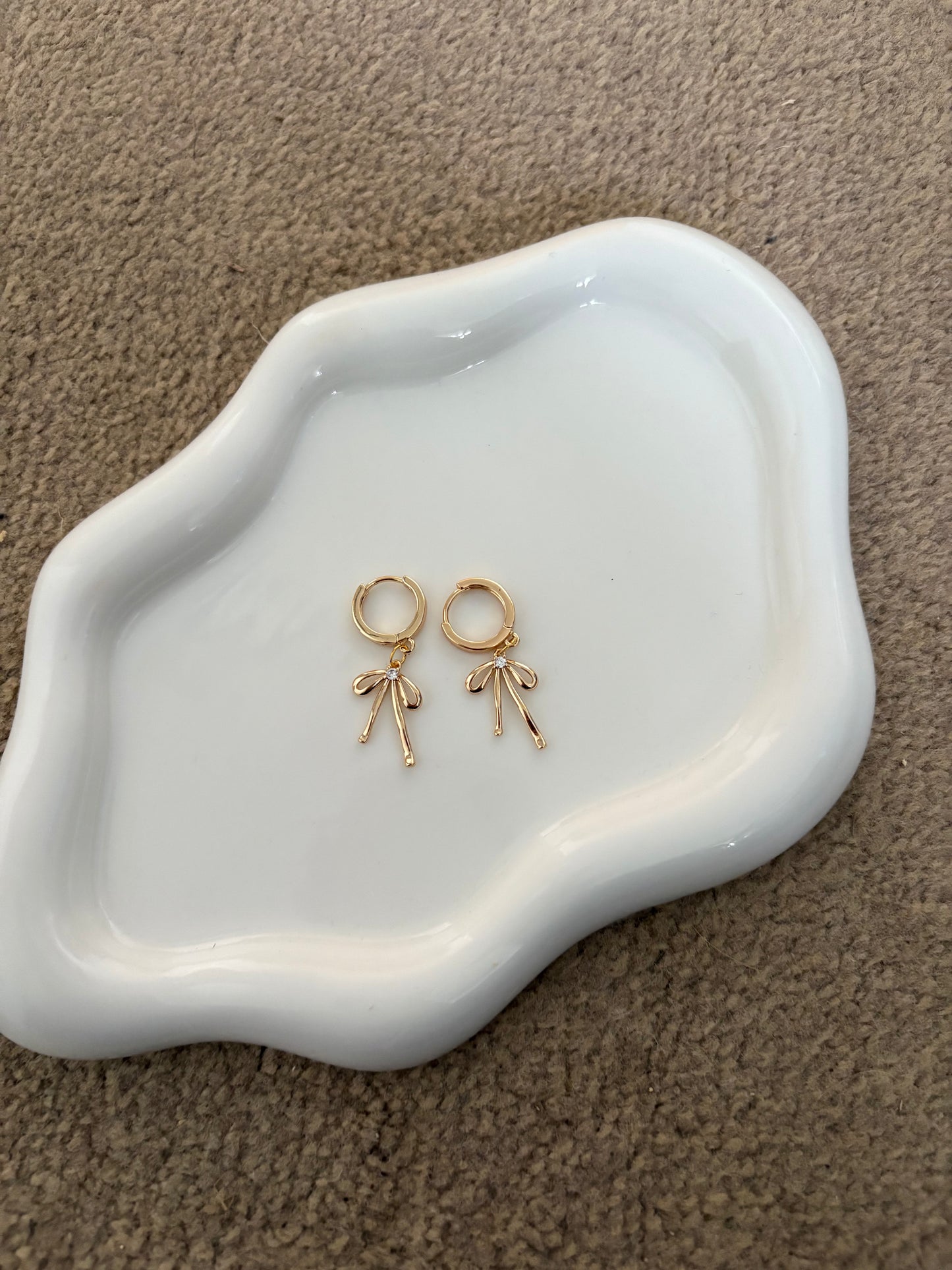 Huggie hoop gold bow earrings